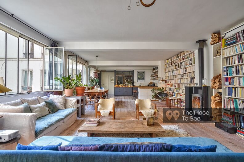 Bright loft with workshop windows and bookcases