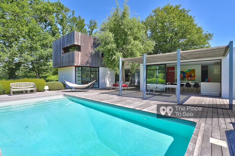 Contemporary house with large bay windows and swimming pool