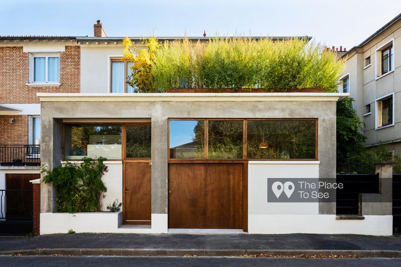 House with photo studio in raw and seventies style