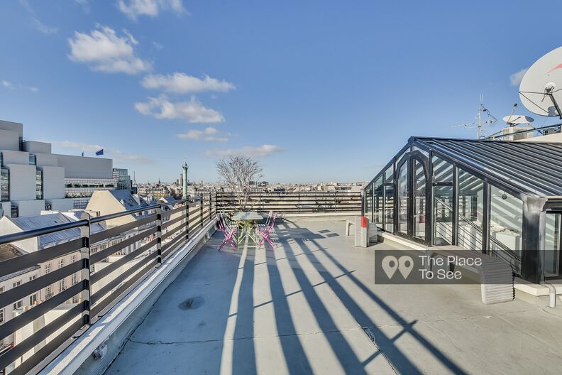 Concrete roof top with a view of the Bastille genius