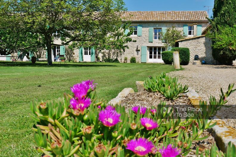 Large stone house with landscaped garden and swimming pool