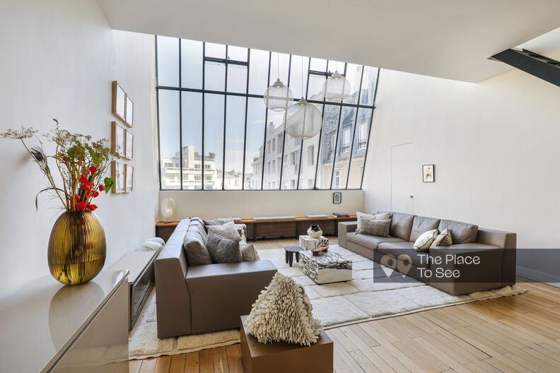 Elegant duplex with a large industrial glass roof